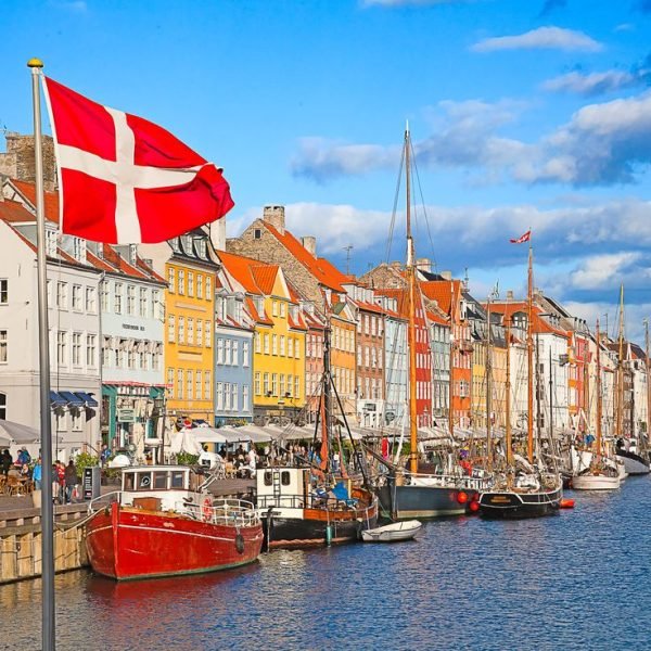 COPENHAGEN, DENMARK - AUGUST 25: unidentified people enjoying sunny weather in open cafees of the famous Nyhavn promenade on August 25, 2010 in Copenhagen, Denmark